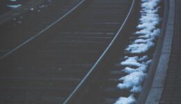 Empty train track lined with snow