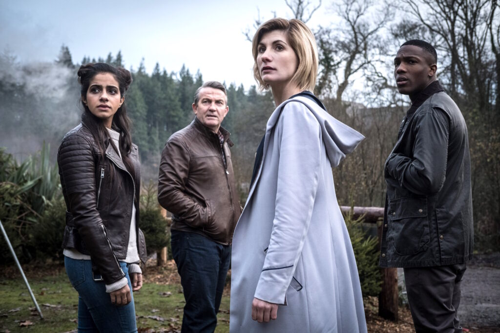 The Thirteenth Doctor (Jodie Whittaker) with her "Tardis Fam" Yasmin Khan (Mandip Gill), Graham O'Brien (Bradley Walsh), and Ryan Sinclair (Tosin Cole)
